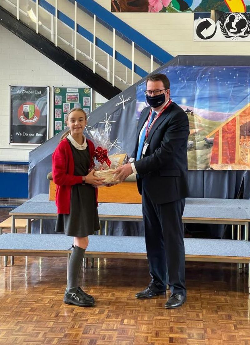Conor McGinn presents Lois in Year 6 with her prize