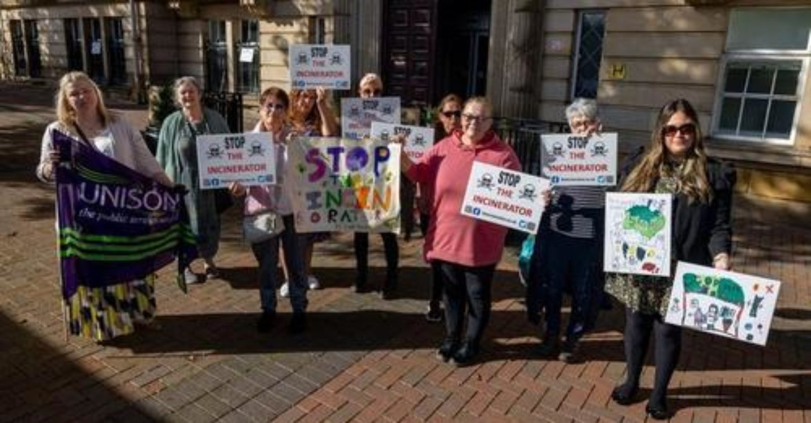 residents in rainford and crank hold signs protesting new hasardous waste 