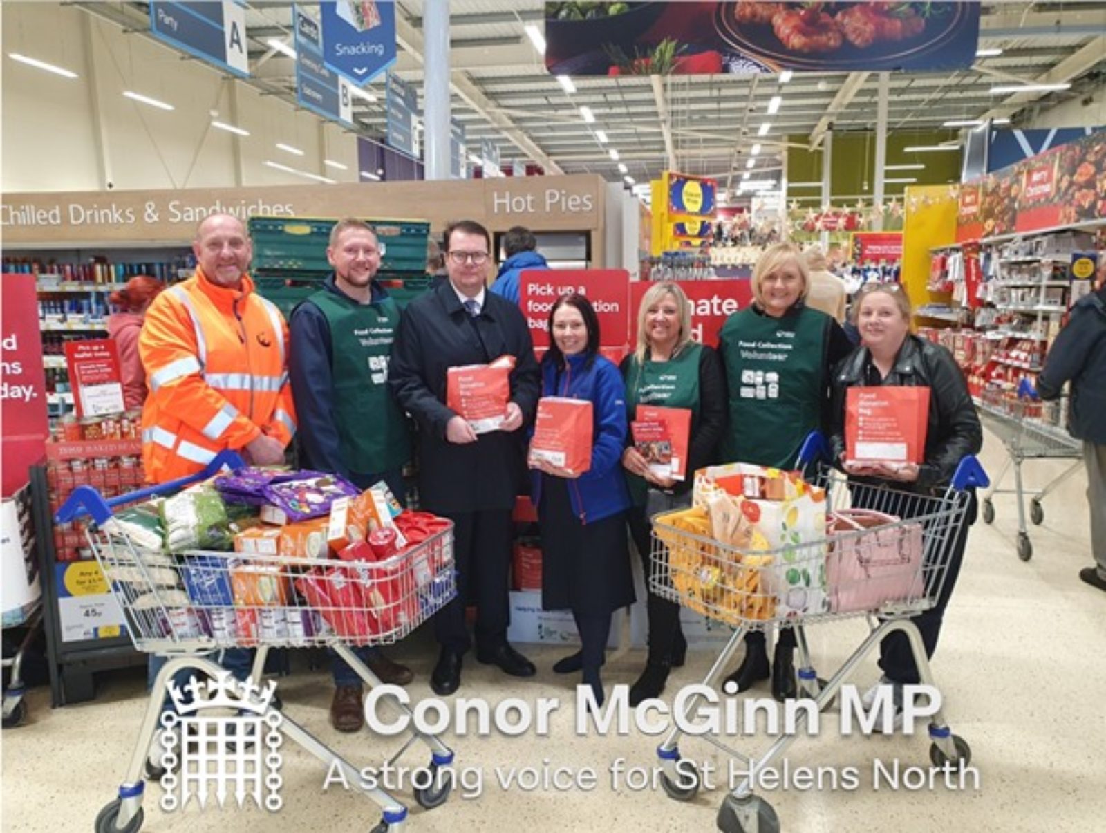 Conor pictured with food bank staff