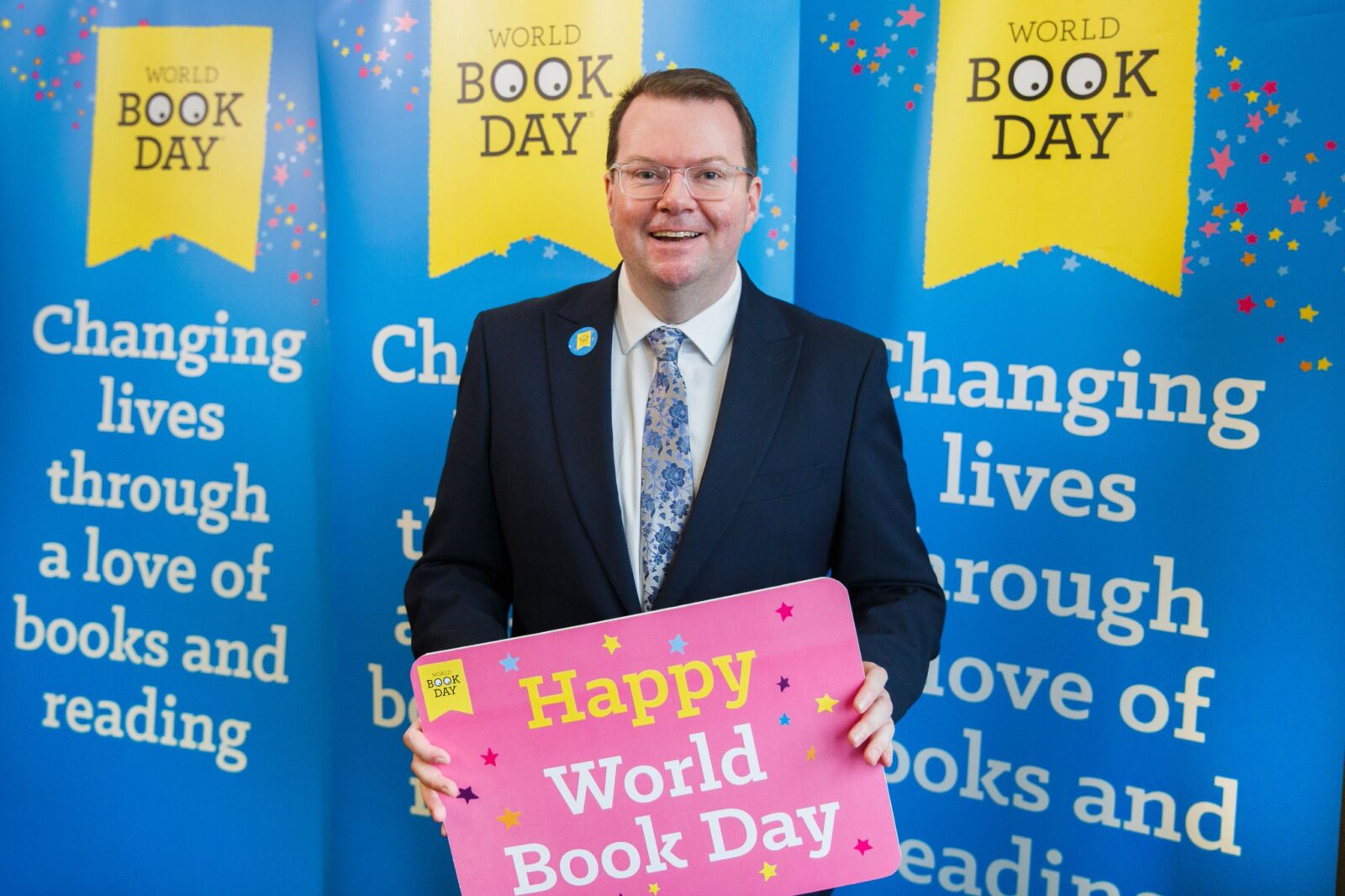 Conor pictured with infornt of "World Book Day" Posters